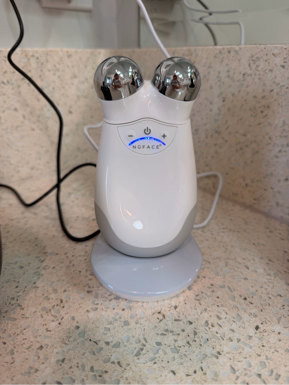 Facial microcurrent device on charging stand